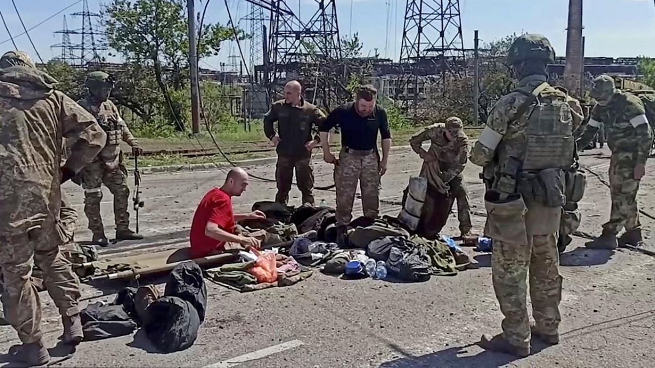 Service members of Ukrainian forces who have surrendered after weeks holed up at Azovstal steel works are being searched by the pro-Russian military in Mariupol, Ukraine, in this still image taken from a video. Credit: Reuters photo/Russian Defence Ministry/Handout