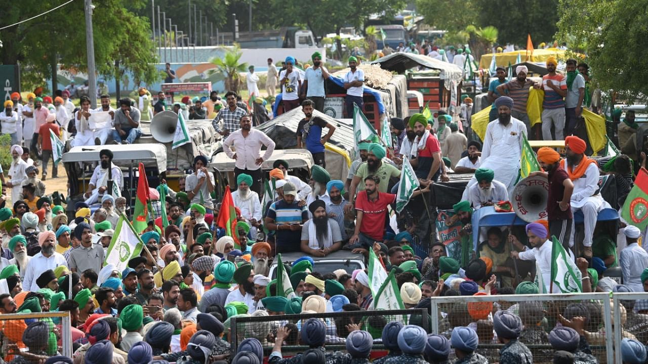 Farmers of the Sanyukt Kisan Morcha protest near Chandigarh-Mohali border after being stopped from heading towards Chandigarh, in Mohali. Credit: PTI photo