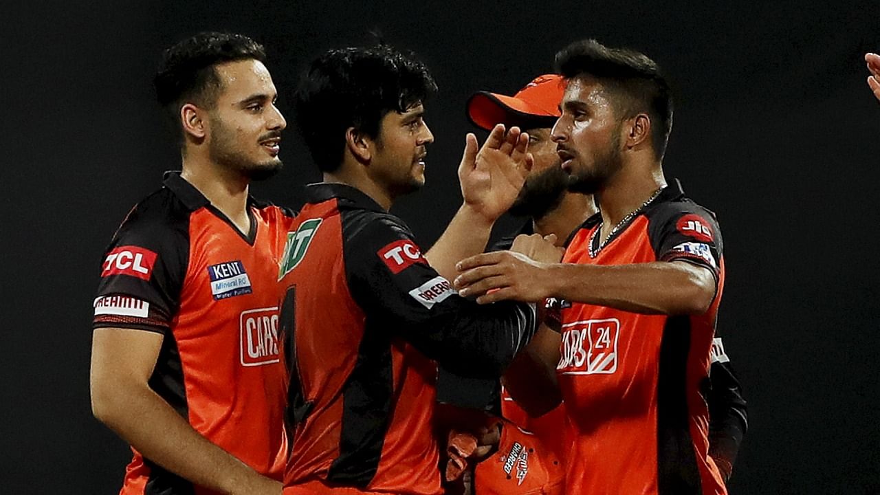 Umran Malik of Sunrisers Hyderabad celebrates with teammates, the wicket of Daniel Sams of Mumbai Indians during the 65th T20 cricket match of the Indian Premier League 2022. Credit: PTI Photo