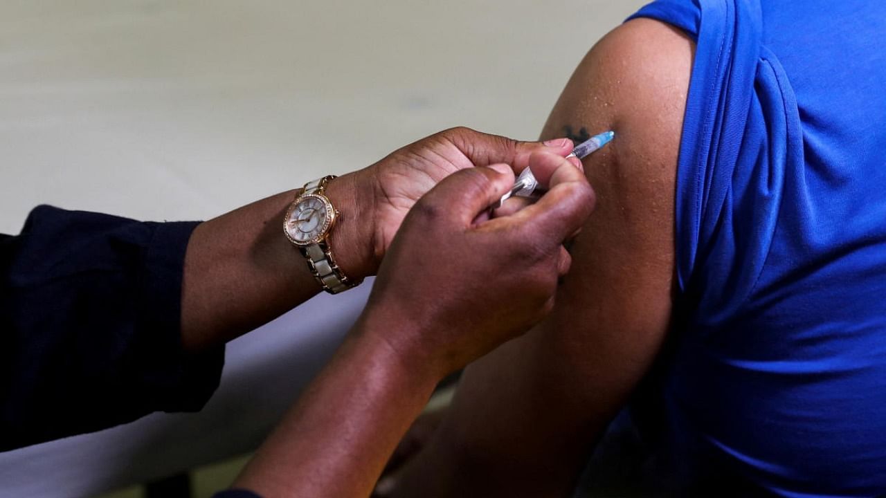 A healthcare worker administers the Pfizer Covid-19 vaccine to a man, amidst the spread of the SARS-CoV-2 variant Omicron, in Johannesburg. Credit: Reuters photo