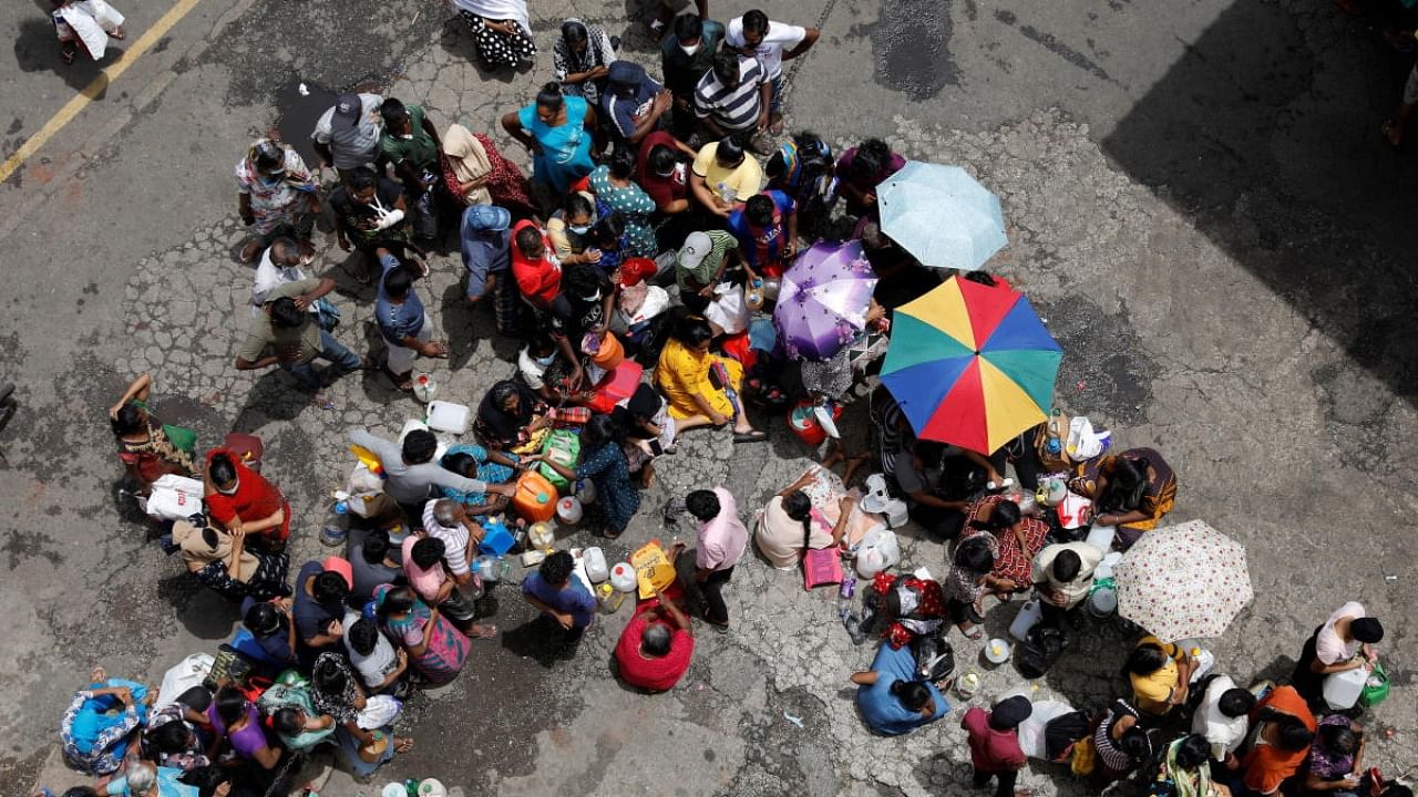 People wait in a queue to buy kerosene at a fuel station, amid Sri Lanka's economic crisis in Colombo. Credit: Reuters photo