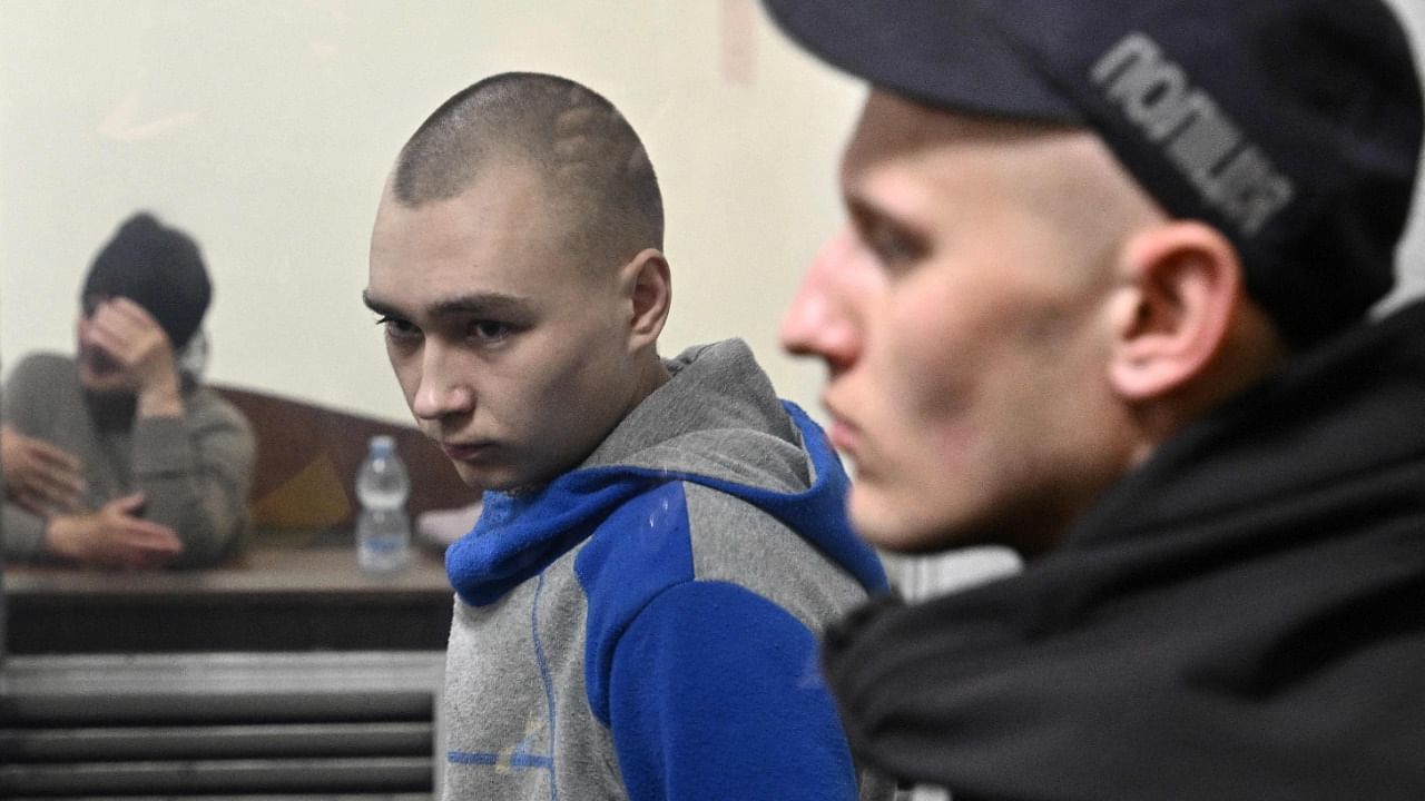 Russian soldier Vadim Shishimarin (C) looks on from the defendant's box at the opening of his trial on charge of War crimes for having killed a civilian. Credit: AFP Photo