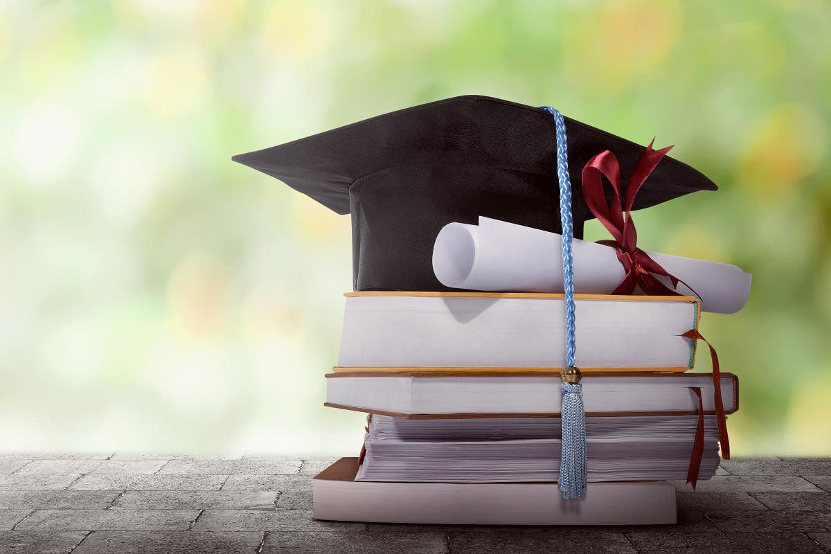 Education challenge burden and school debt concept as a group of mortarboards or graduate cap being lifted higher with one sinking weighted down by a rock with 3D illustration elements. Credit: iStock Photo