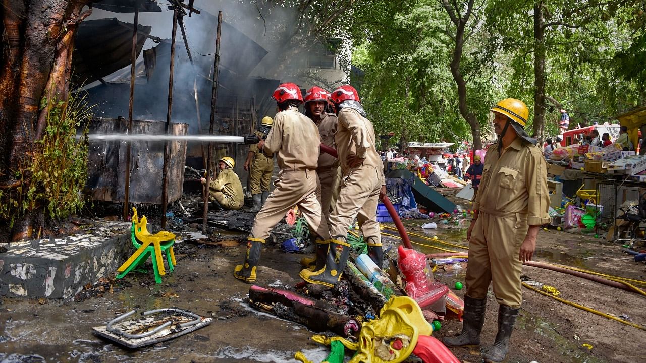 Firefighters try to douse a fire that broke out in Jhandewalan's cycle market, in New Delhi. Credit: PTI Photo
