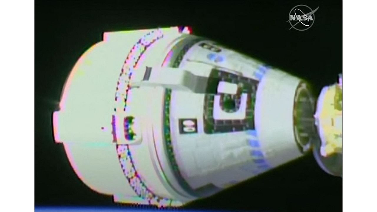 In this handout video grab courtesy of NASA TV, Boeing's Starliner capsule (L) docks with the International Space Station (ISS) on May 20, 2022. Credit: AFP Photo