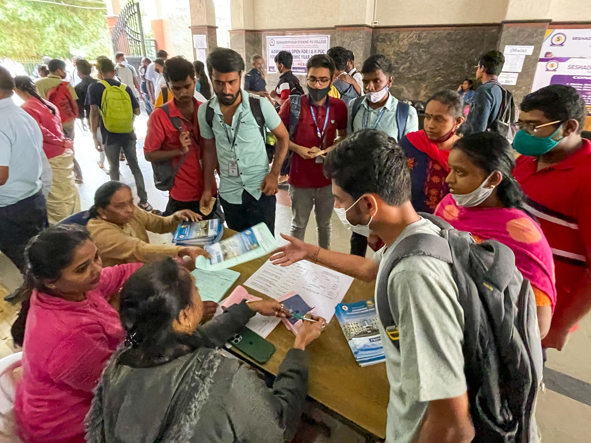 Students and parents collect admission forms for PU courses at a college in the city. Credit: DH File Photo