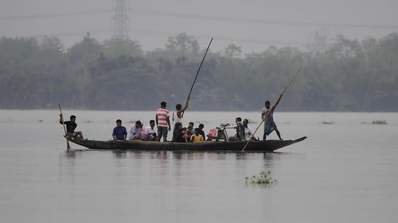People move to safer places from flood hit villages in Hojai District of Assam. Credit: IANS Photo