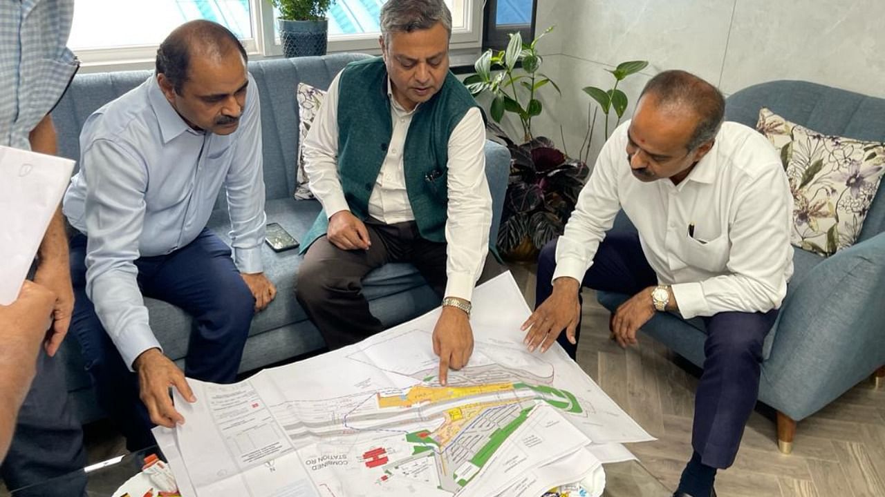 Bangalore Central MP P C Mohan reviews work on a road over bridge with officials from the South Western Railway. Credit: Special Arrangement