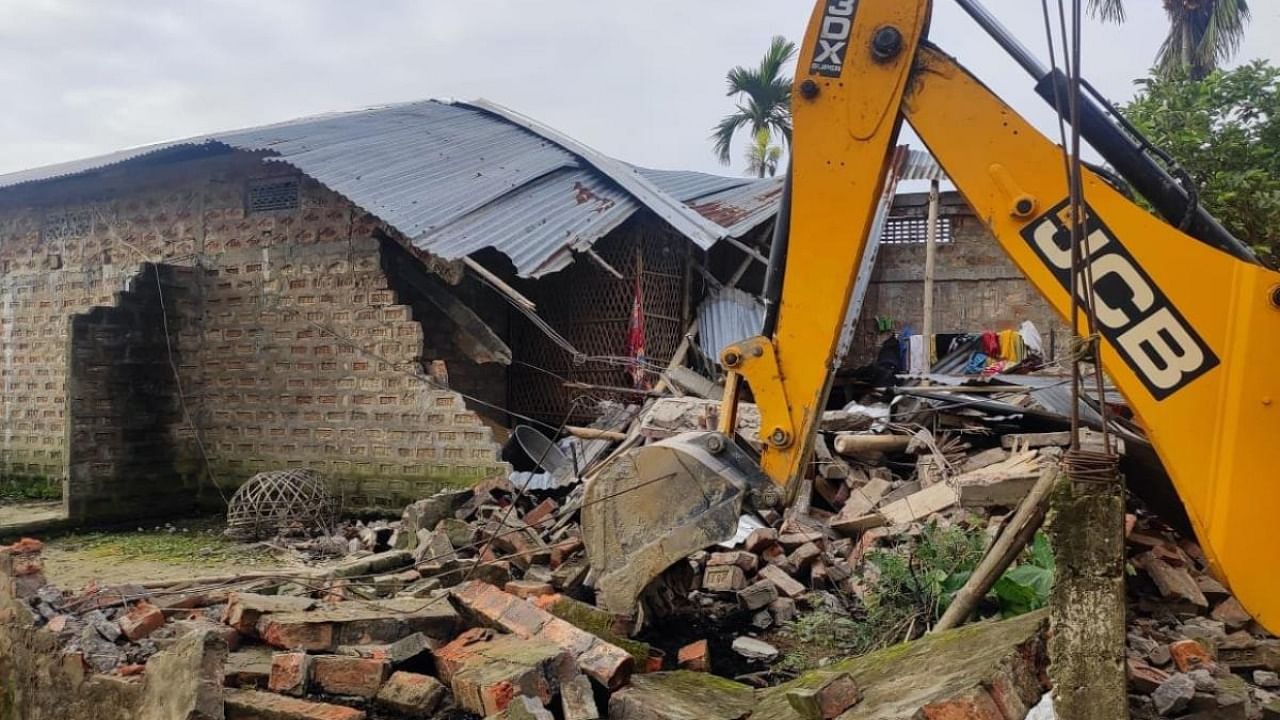 A JCB machine during an eviction drive carried out by district administration after incidents of violence at Batadrava in Nagaon District of Assam. Credit: IANS photo