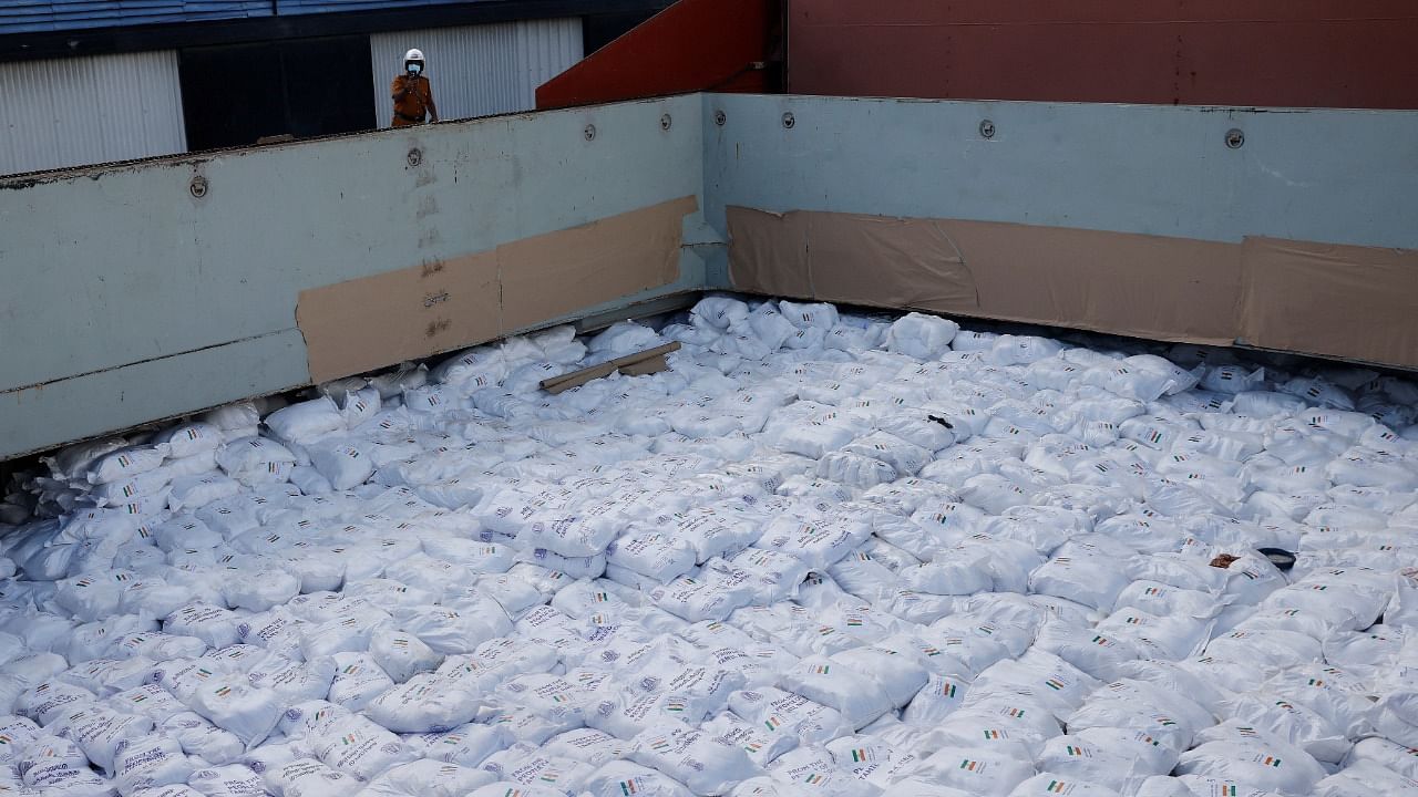 A security personnel takes a picture of the humanitarian aid sent from India inside a cargo ship, amid the country's economic crisis, at a port in Colombo. Credit: Reuters Photo