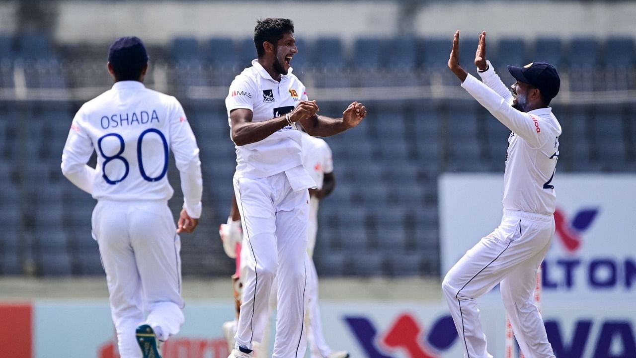 Sri Lanka's Kasun Rajitha (C) celebrates with teammates after dismissing Bangladesh's Mahmudul Hasan Joy. Credit: AFP Photo