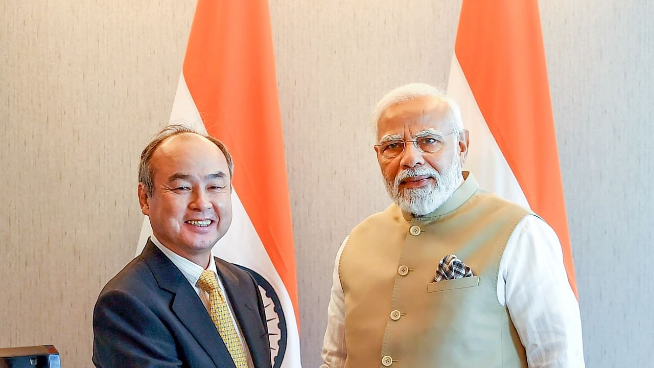 Prime Minister Narendra Modi with Softbank Group Corp. President and CEO Masayoshi Son during a meeting, in Tokyo. Credit: PTI Photo