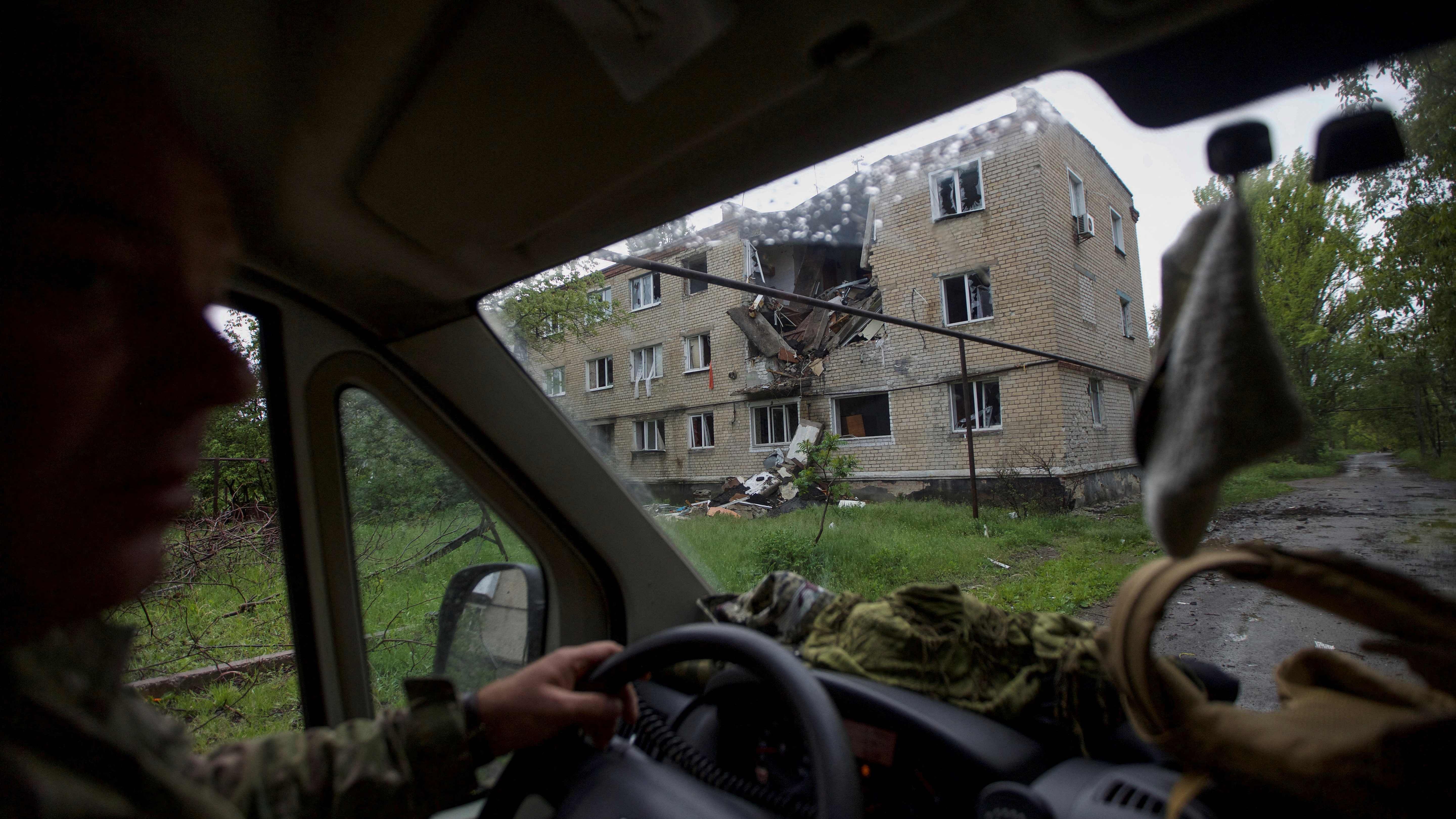 A residential building damaged by a Russian military strike in seen through a window of an ambulance car, as Russia's attack on Ukraine continues, in the town of Marinka, in Donetsk region. Credit: Reuters Photo