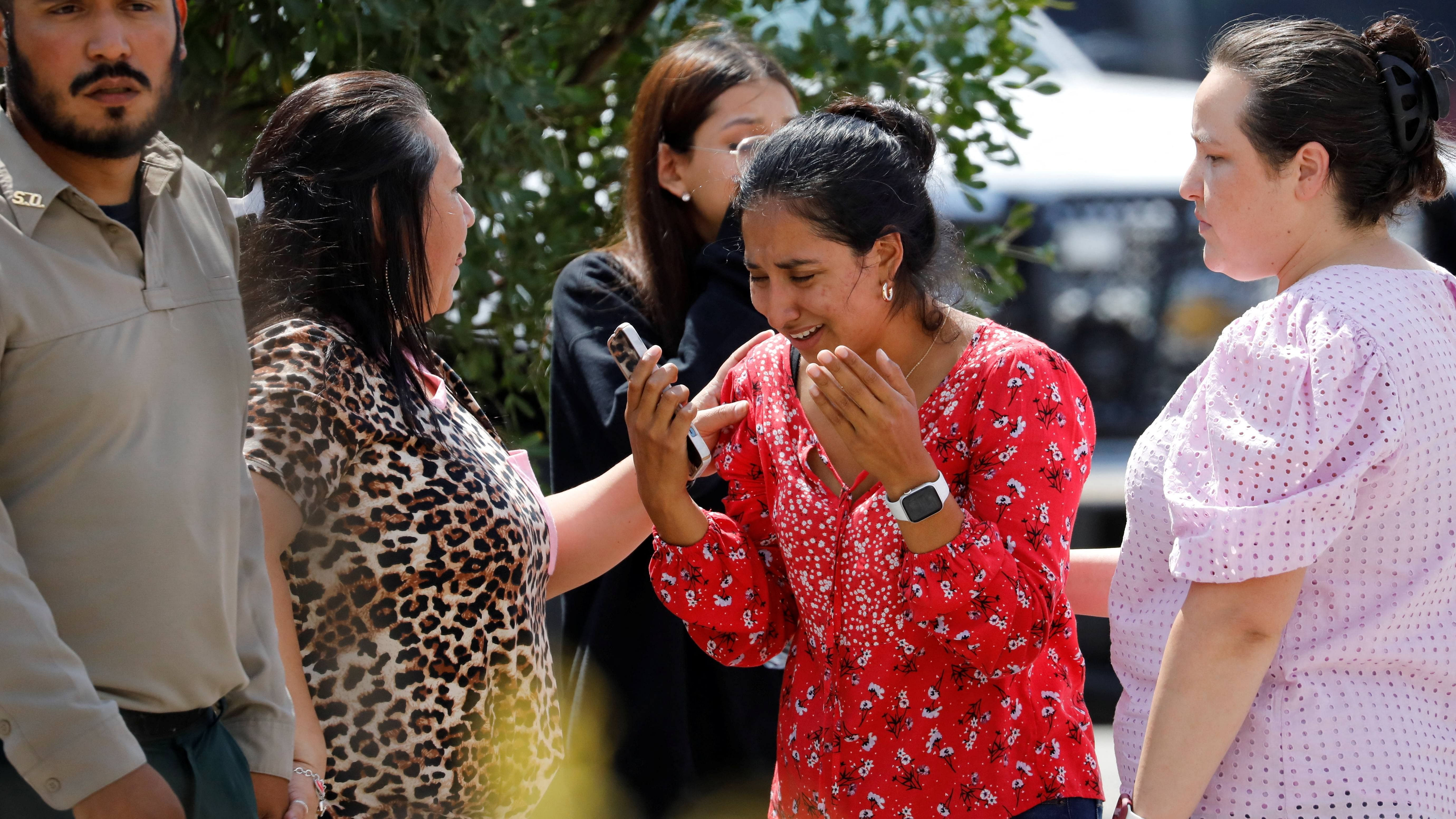 A woman reacts outside the Ssgt Willie de Leon Civic Center, where students had been transported from Robb Elementary School after a shooting. Credit: Reuters Photo