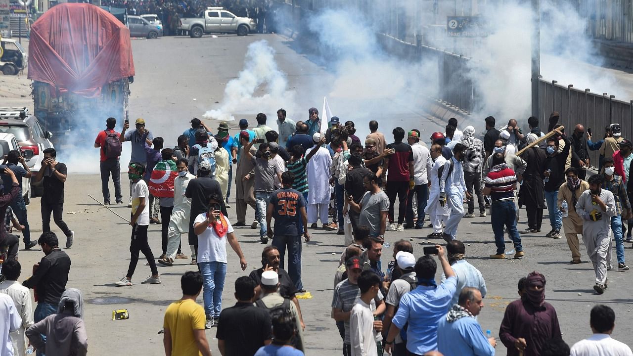 Police use tear gas to disperse activists of the Pakistan Tehreek-e-Insaf (PTI) party of ousted prime minister Imran Khan during a protest in Lahore. Credit: PTI Photo