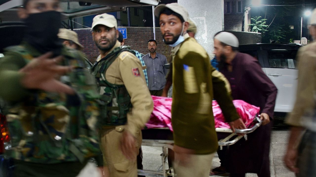 Police carry the body of Amreen Bhat, a local TV artist who was shot dead by militants at her home in Chadoora, at the SMHS hospital. Credit: PTI Photo