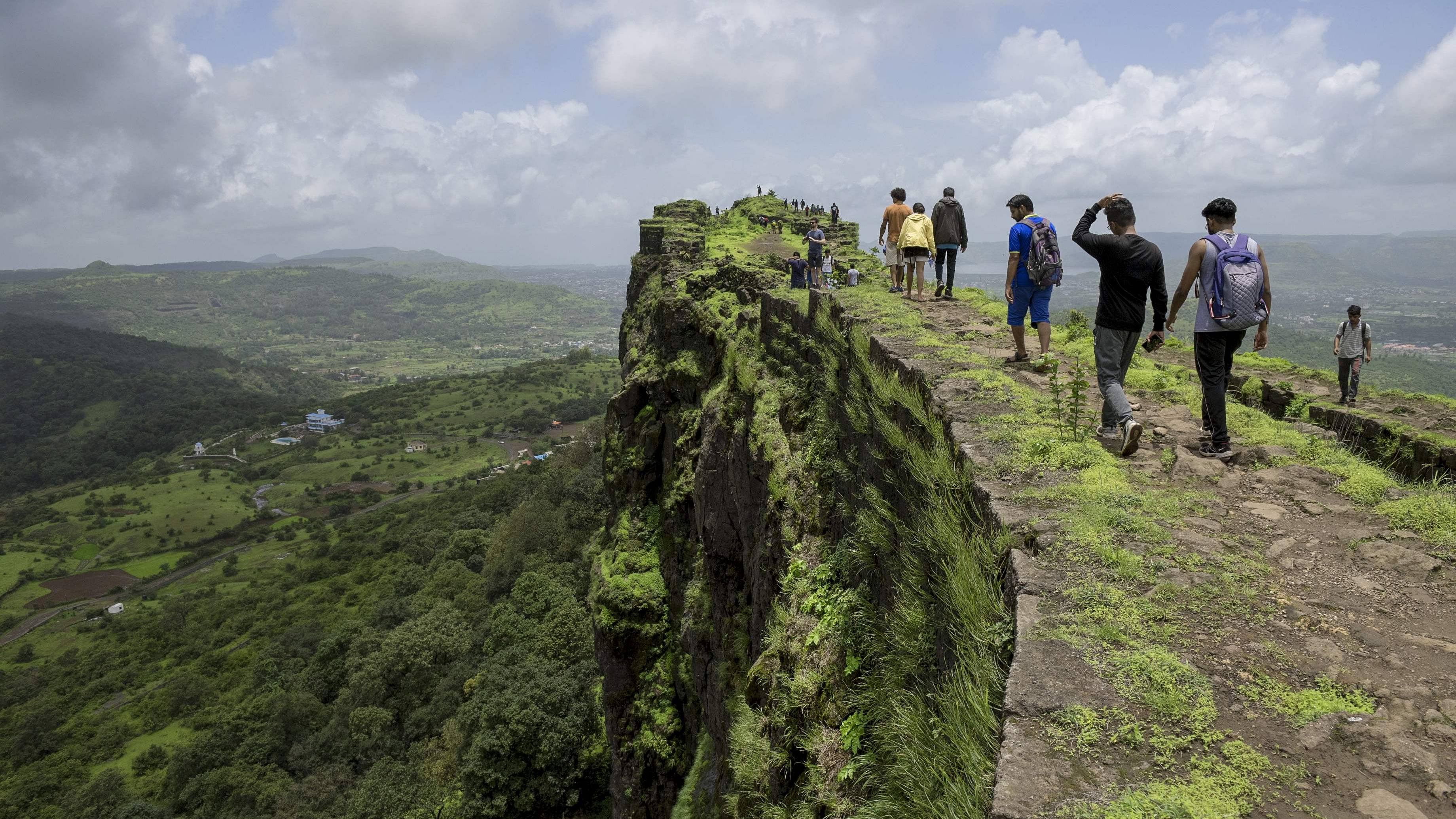 In this photo taken on June 30, 2018 visitors walk along the ruins of the Lohagad hill fort, near Lonavla in the western Indian state of Maharashtra. First built upon by Indian dynasties stretching back to the Satavahana Empire around the first century BC. Credit: AFP Photo