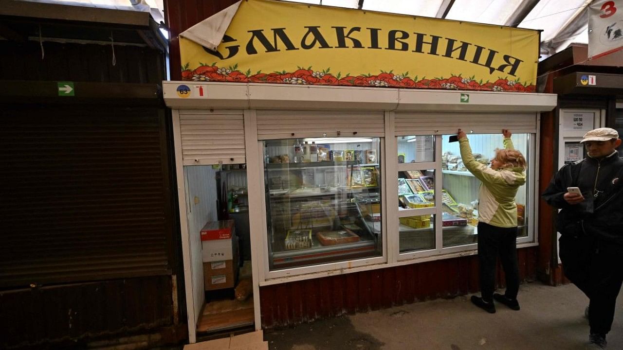 A seller opens her kiosk in reopened market in Bucha, Kyiv region. Credit: AFP Photo