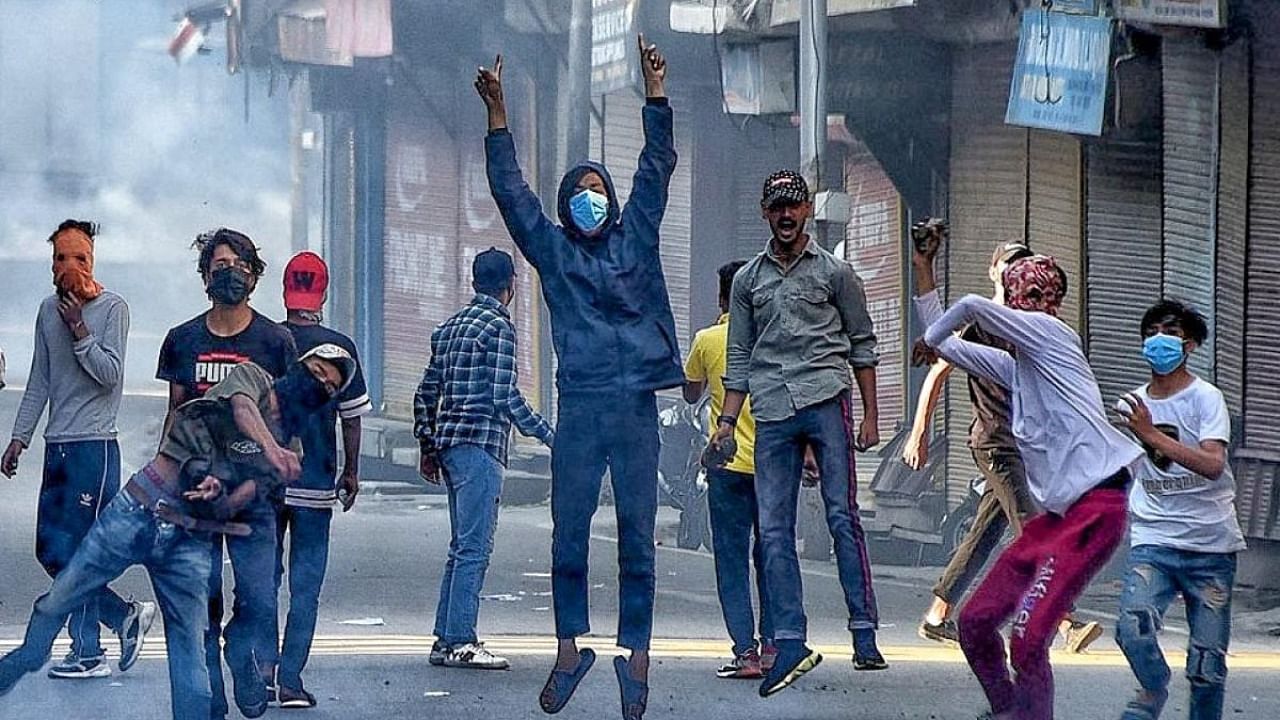 Protesters clash with security forces during a protest against sentencing of Kashmiri separatist leader Yasin Malik, in Srinagar, on Wednesday, May 25, 2022. Credit: IANS Photo