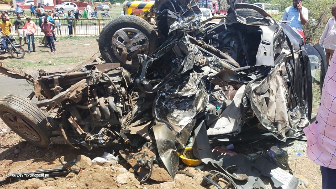 Mangled remains of car that collided with a truck killing four people on spot near Stavanidhi service road on the outskirts of Nipani town in Belagavi district on Friday. Credit: Special Arrangement