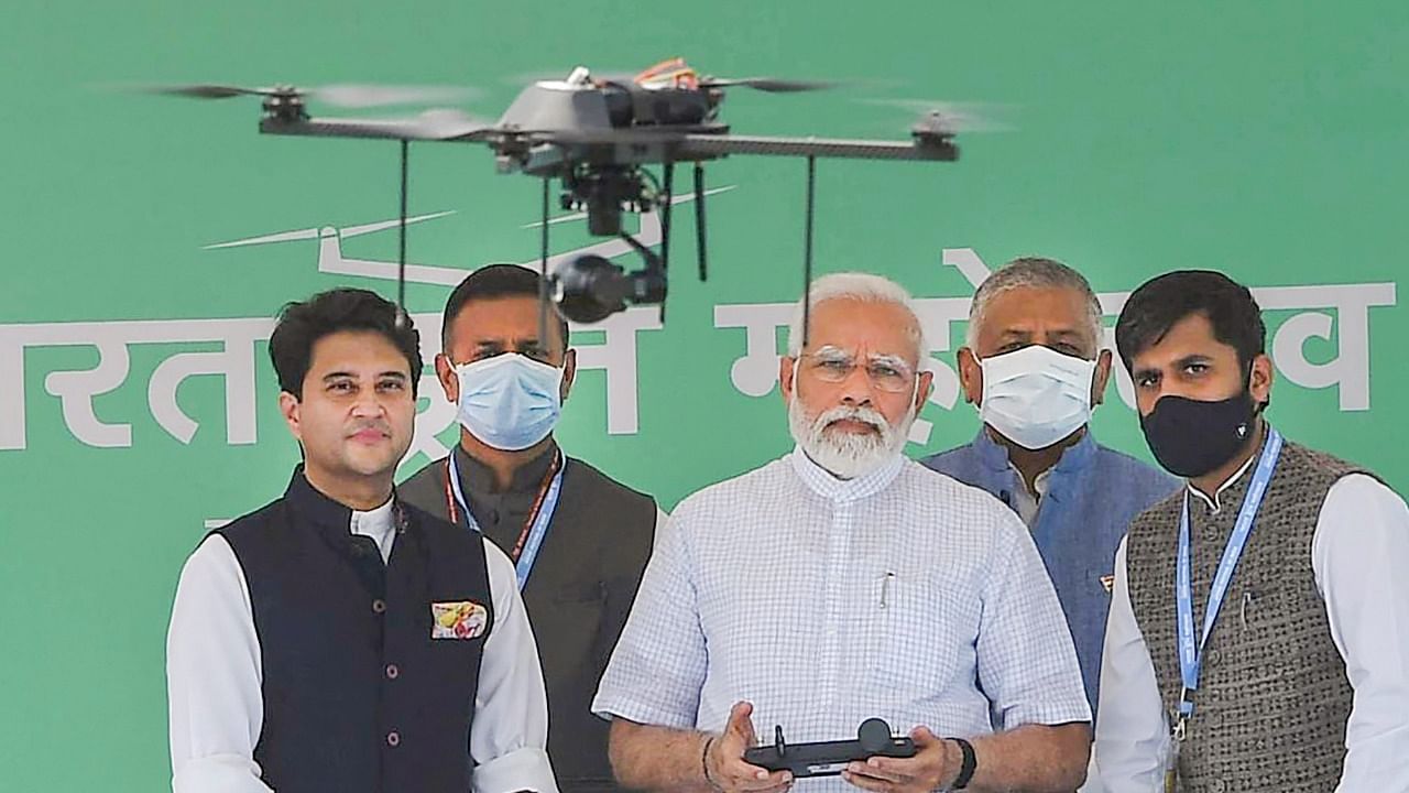 Prime Minister Narendra Modi flies a drone at the inauguration of the Bharat Drone Mahotsav, at Pragati Maidan in New Delhi. Credit: PTI Photo