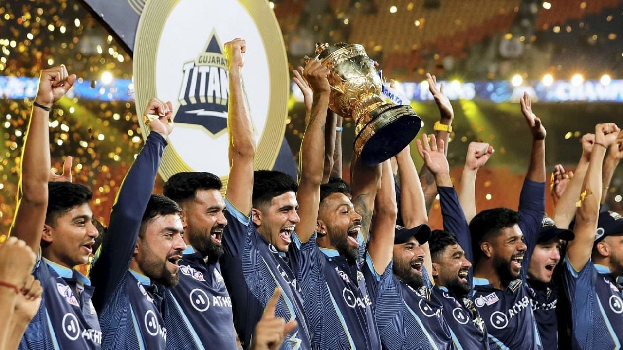 Gujarat Titans players celebrate with the IPL trophy after winning the final against Rajasthan Royals in Ahmedabad on Sunday. Titans emulated Royals by winning the title in their debut season. Credit: PTI Photo/Sportspicz for IPL