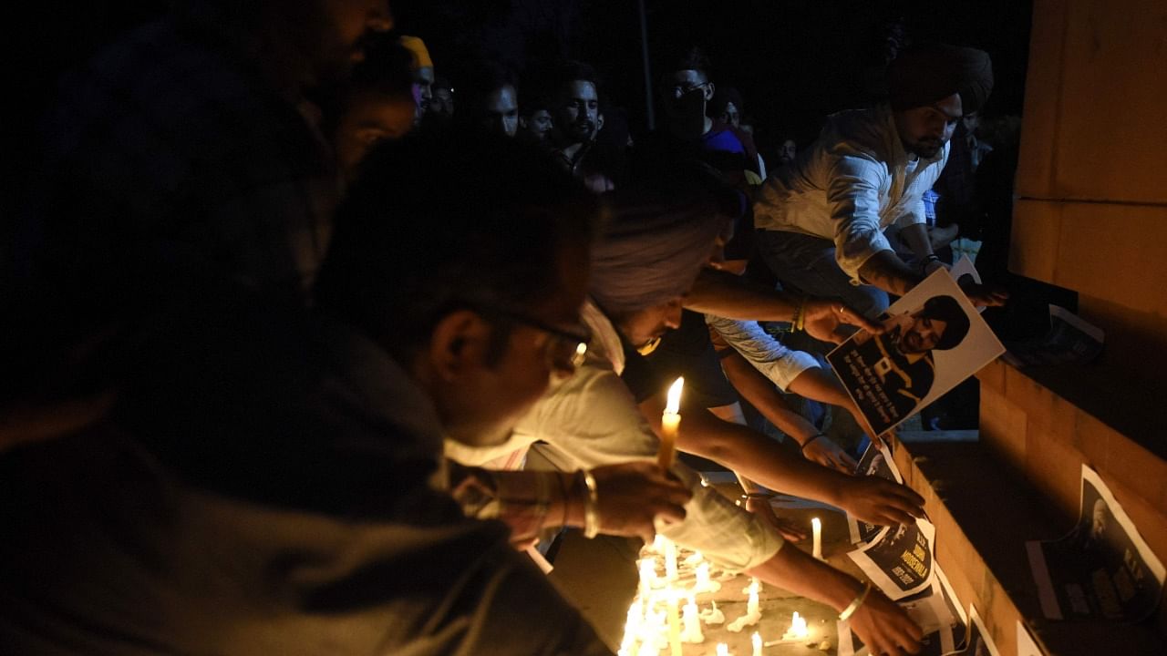 Youths pay tribute during a candlelight vigil for the late Indian rapper Sidhu Moose Wala, whose real name is Shubhdeep Singh Sidhu. Credit: PTI Photo