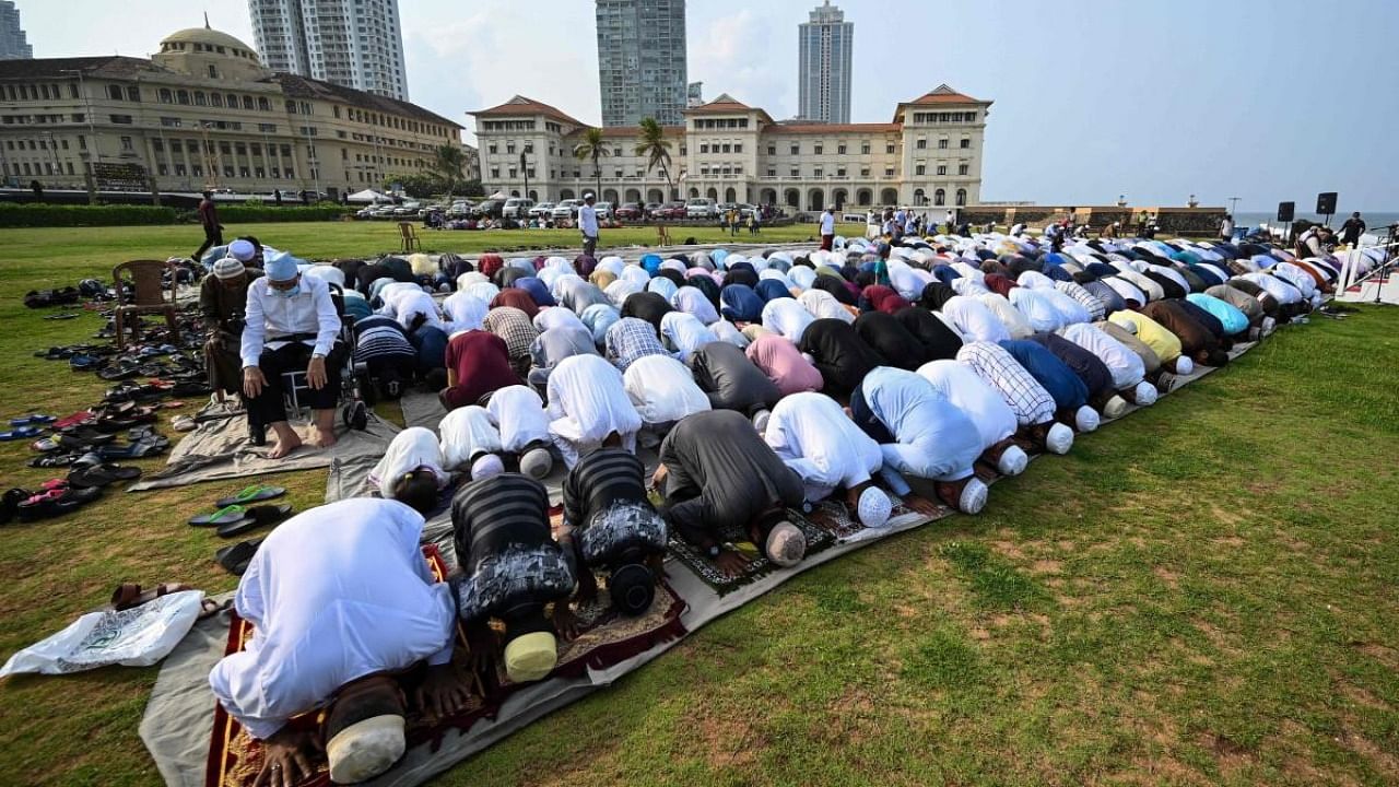 Muslim devotees offer a special morning prayer to start the Eid al-Fitr festival, which marks the end of their holy fasting month of Ramadan. Credit: AFP Photo