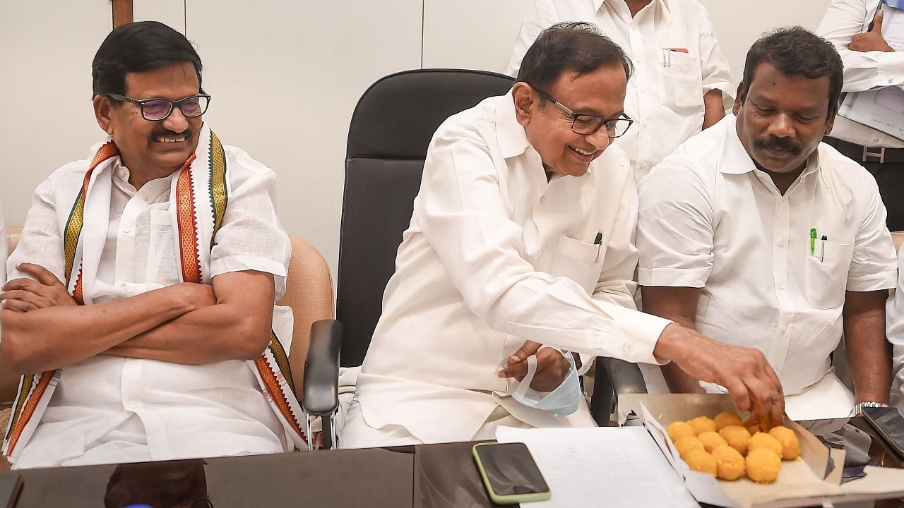  Senior Congress leader P. Chidambaram has sweets after filing his nomination papers for Rajya Sabha elections, at Tamil Nadu Secretariat. Credit: PTI Photo