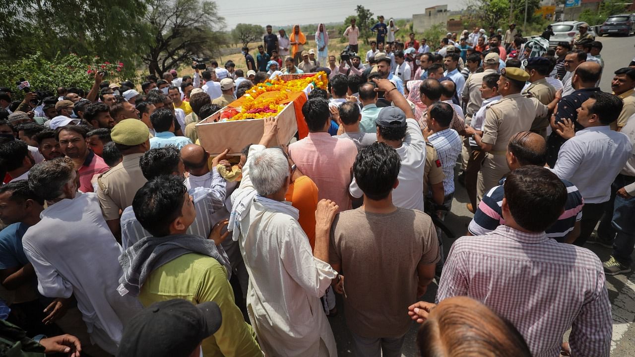 Relatives and family members of government teacher Rajni Bala during her funeral, in Samba. Credit: PTI Photo