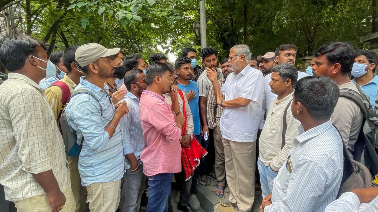 BJP MLA S Suresh Kumar meets candidates who are awaiting KPSC exam results in front of the KPSC building in Bengaluru on Tuesday. Credit: DH Photo/Pushkar V