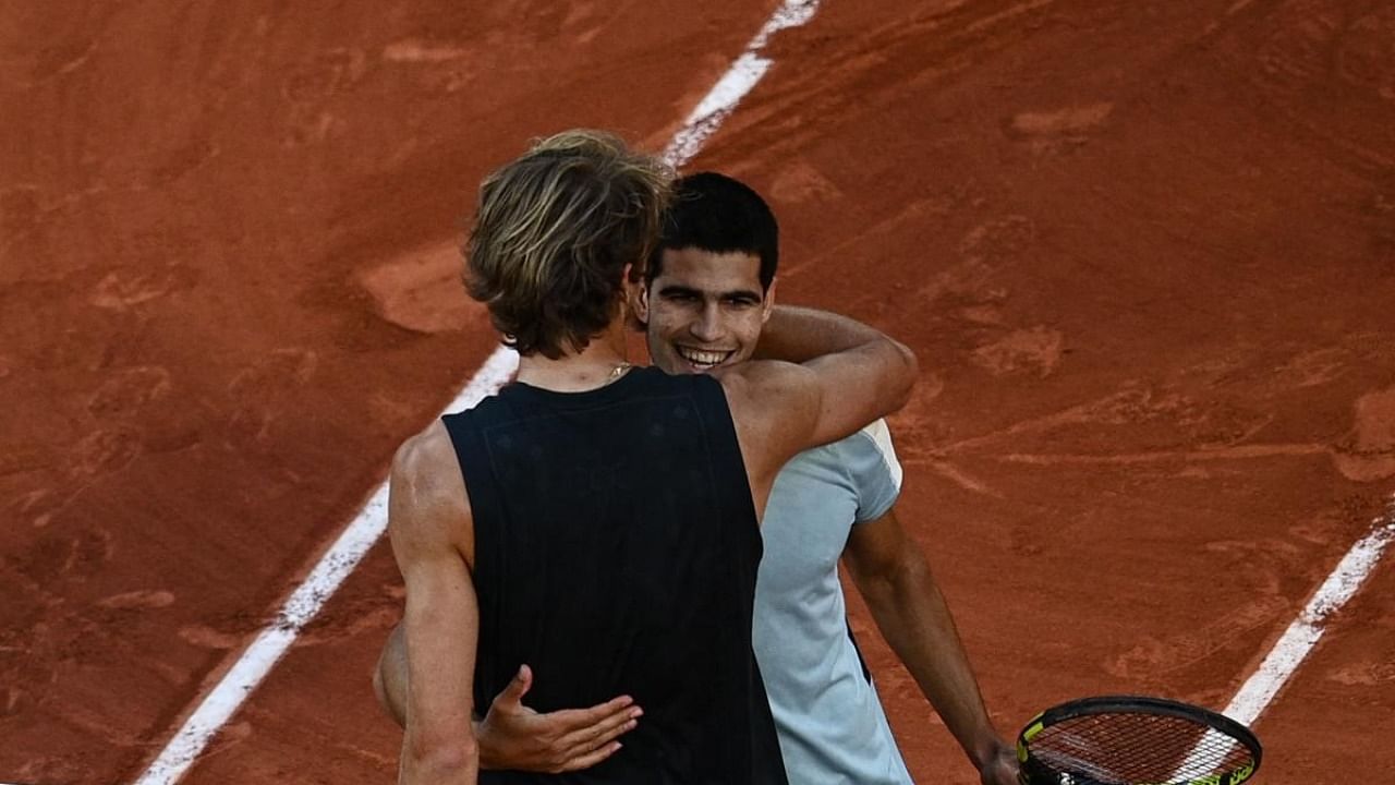 Germany's Alexander Zverev (L) greets Spain's Carlos Alcaraz (R) after winning their men's quarter-final singles match on day ten of the Roland-Garros Open tennis tournament at the Court Philippe-Chatrier in Paris. Credit: AFP Photo