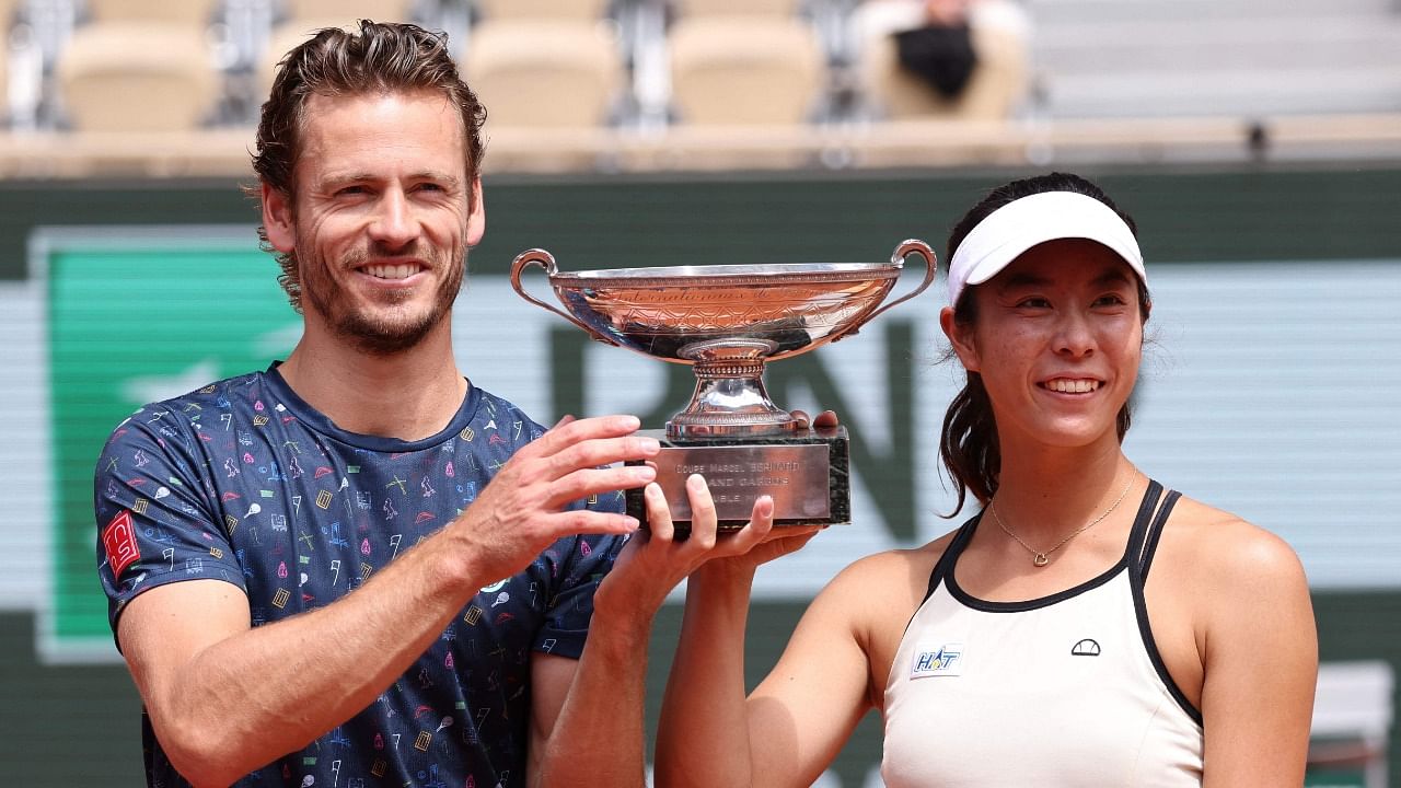 Japan's Ena Shibahara (R) and Netherlands' Wesley Koolhof celebrate with their trophy after winning their mix doubles final match. Credit: AFP Photo