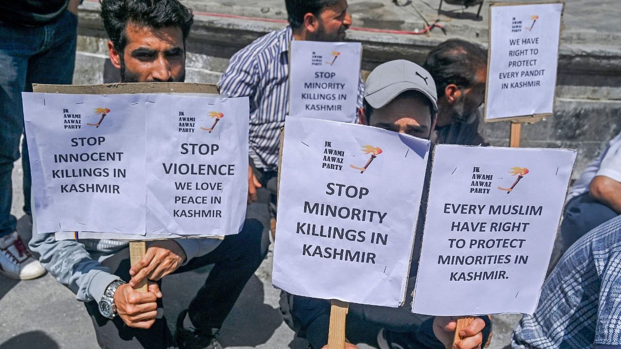 Activists from Jammu and Kashmir Awami Aawaz Party hold placards during a protest against the assassination in Srinagar. Credit: AFP Photo