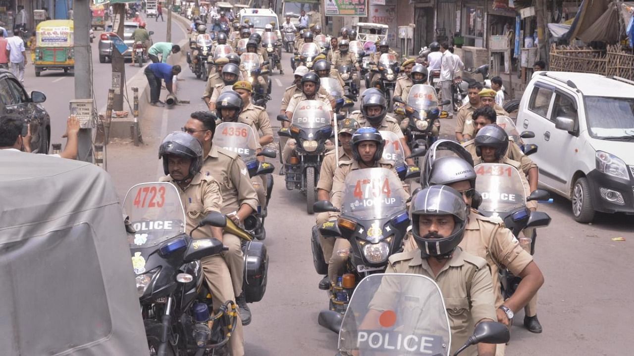 Police personnel patrol in a locality, a day after clashes broke out between two groups over market shutdown, in Kanpur. Credit: PTI Photo
