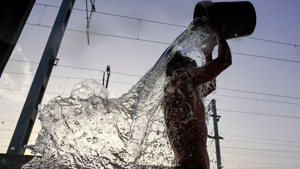 A man bathes to get respite from the heat on a hot summer day. Credit: PTI Photo