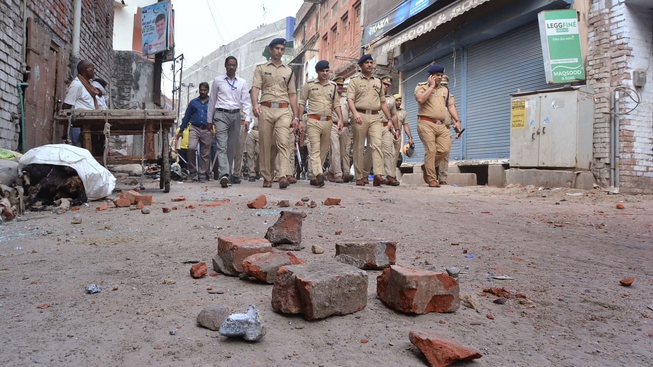 Police conduct flag march in a locality, a day after clashes broke out between two groups over market shutdown, in Kanpur. Credit: PTI Photo