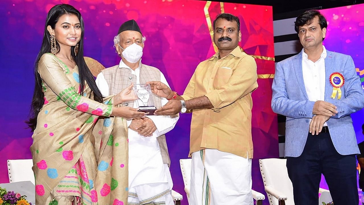 Dr. L. Murugan presents Silver Conch for Best Documentary Film (below 60 mins) in National Competition category to Aimee Barua, director of Screaming Butterflies. Credit: PTI Photo