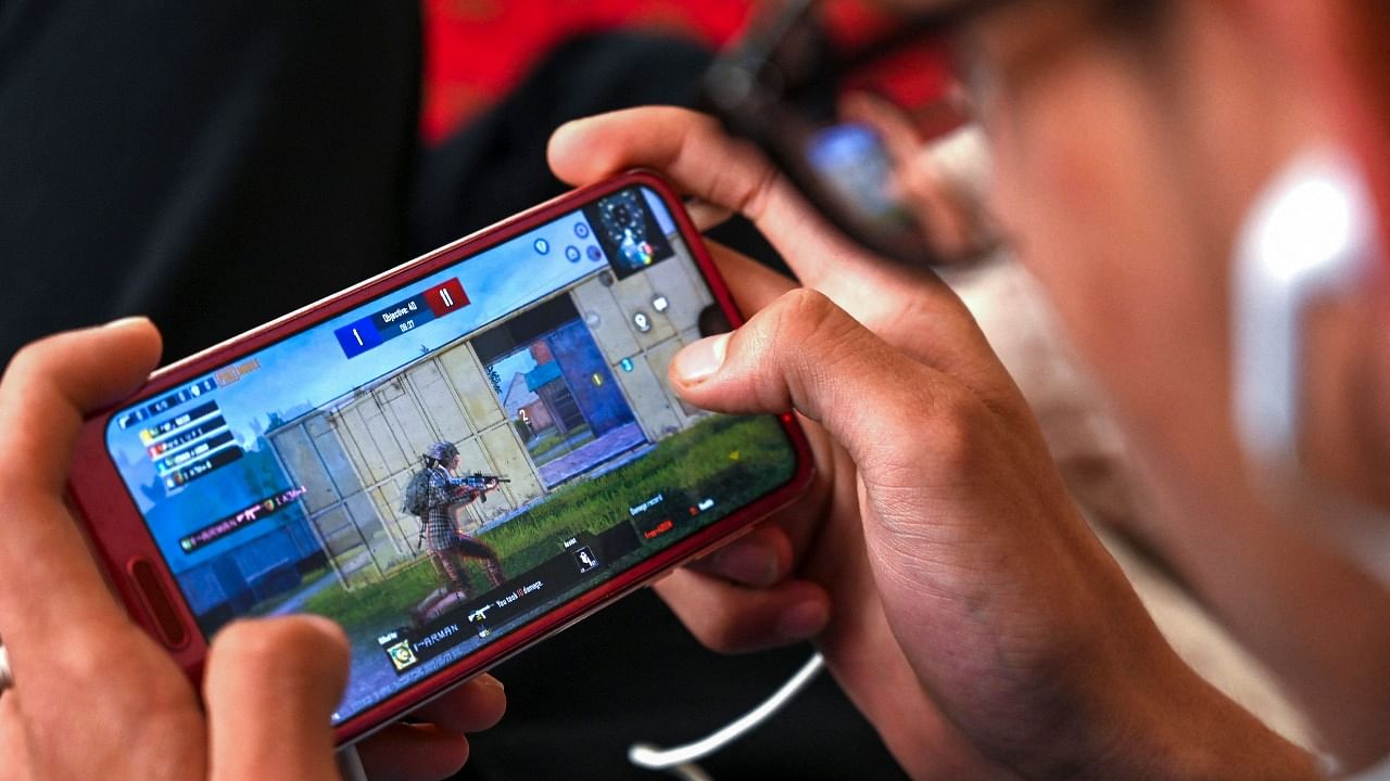 An Afghan boy plays the video game 'PlayerUnknown's Battlegrounds' or PUBG on a mobile phone at his home in Kabul. Credit: AFP Photo