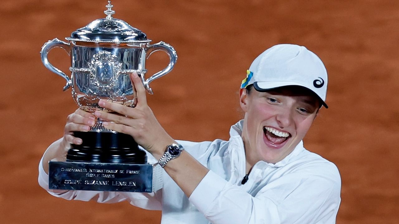 Poland's Iga Swiatek celebrates with the cup after defeating Coco Gauff. Credit: AP Photo 