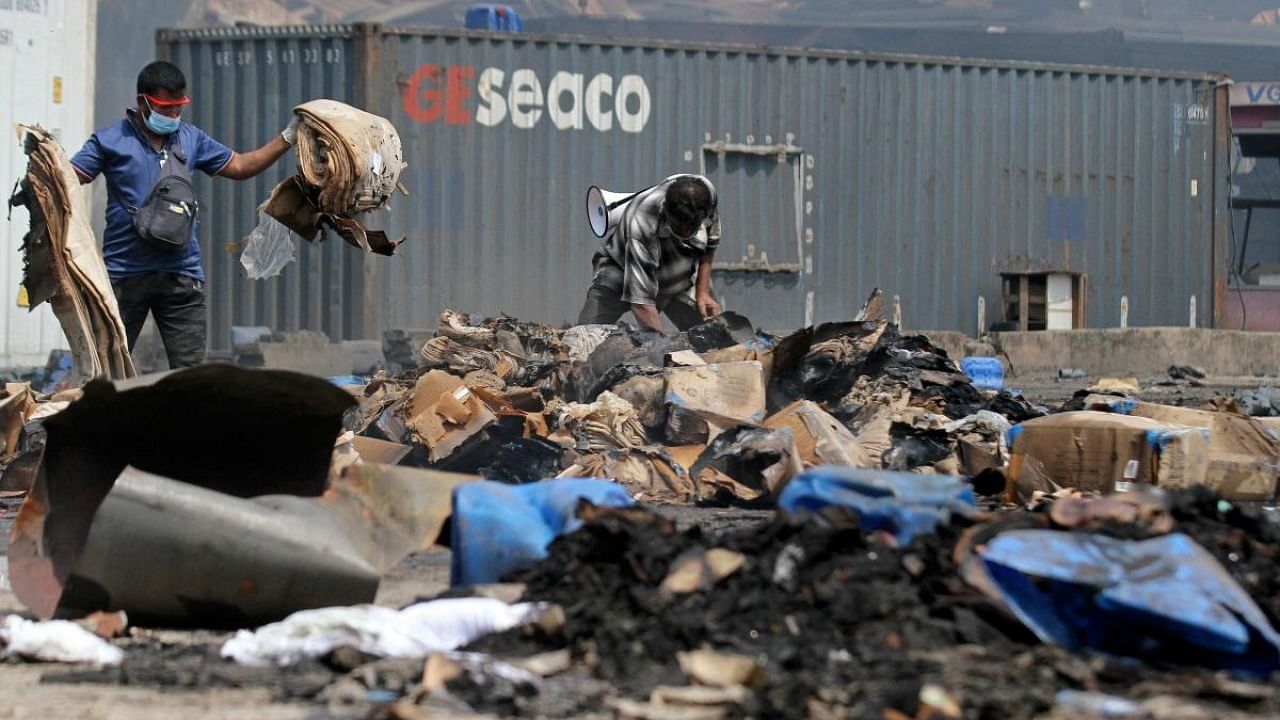 Officials inspect the site after a fire that broke out at a shipping container storage facility in Sitakunda, about 40 km (25 miles) from the key port of Chittagong. Credit: AFP Photo