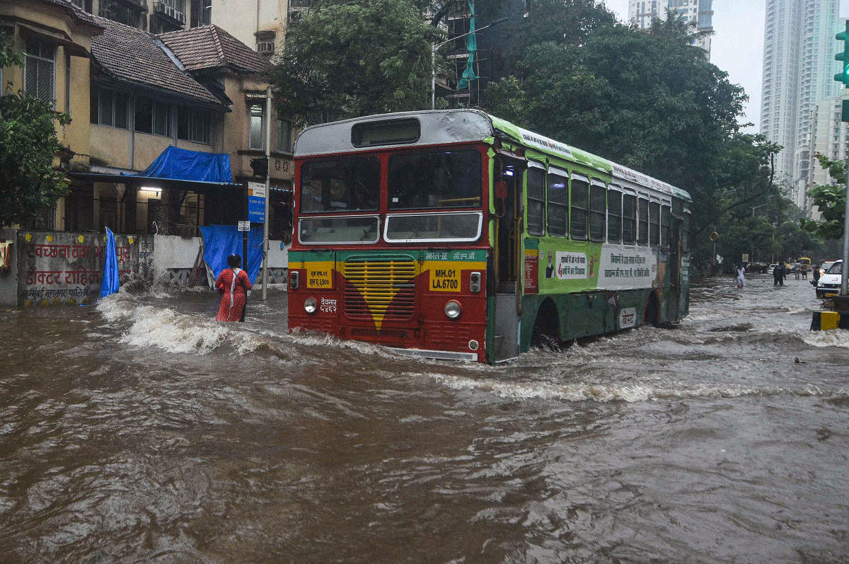 Mumbai: A bus moves through a waterlogged street during Cyclone Tauktae after heavy rains, in Mumbai, Monday, May 17, 2021. Credit: PTI Photo