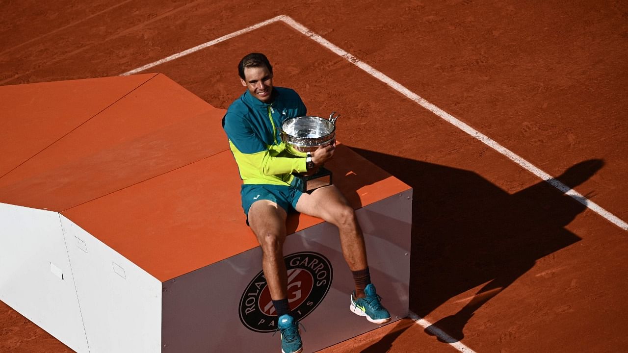 Spain's Rafael Nadal poses with The Musketeers' Cup as he celebrates after victory over Norway's Casper Ruud during their men's singles final match on day fifteen of the Roland-Garros Open tennis tournament at the Court Philippe-Chatrier in Paris. Credit: AFP Photo