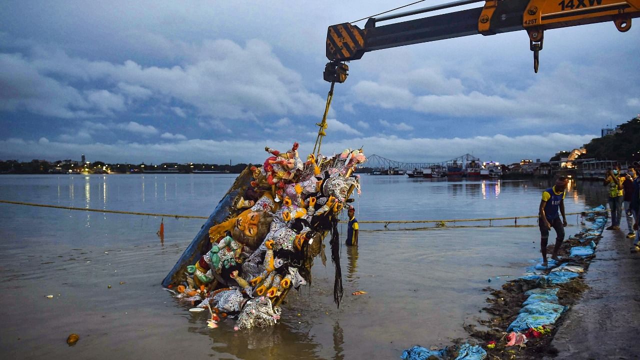 A crane being used to lift an idol of Goddess Durga after immersion to prevent pollution in River Ganga. Credit: PTI File Photo