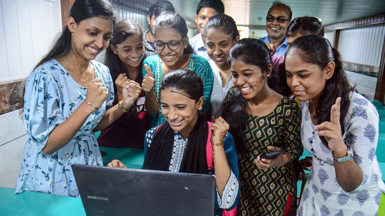 Students pose as they check their Maharashtra Board class 12th exam results, in Thane. Credit: PTI Photo