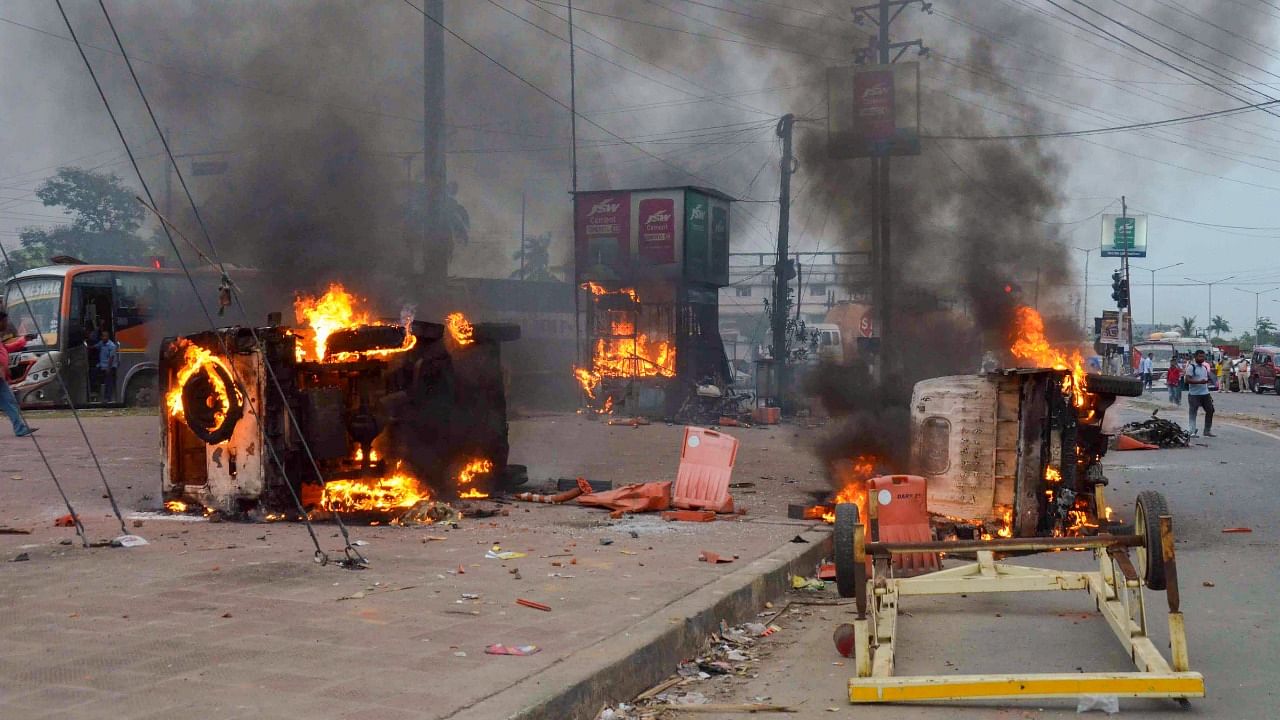 Flames and smoke rise from vehicles on fire, that were allegedly set ablaze by miscreants during the protest in Howrah, on Friday, June 10, 2022. Credit: PTI File Photo