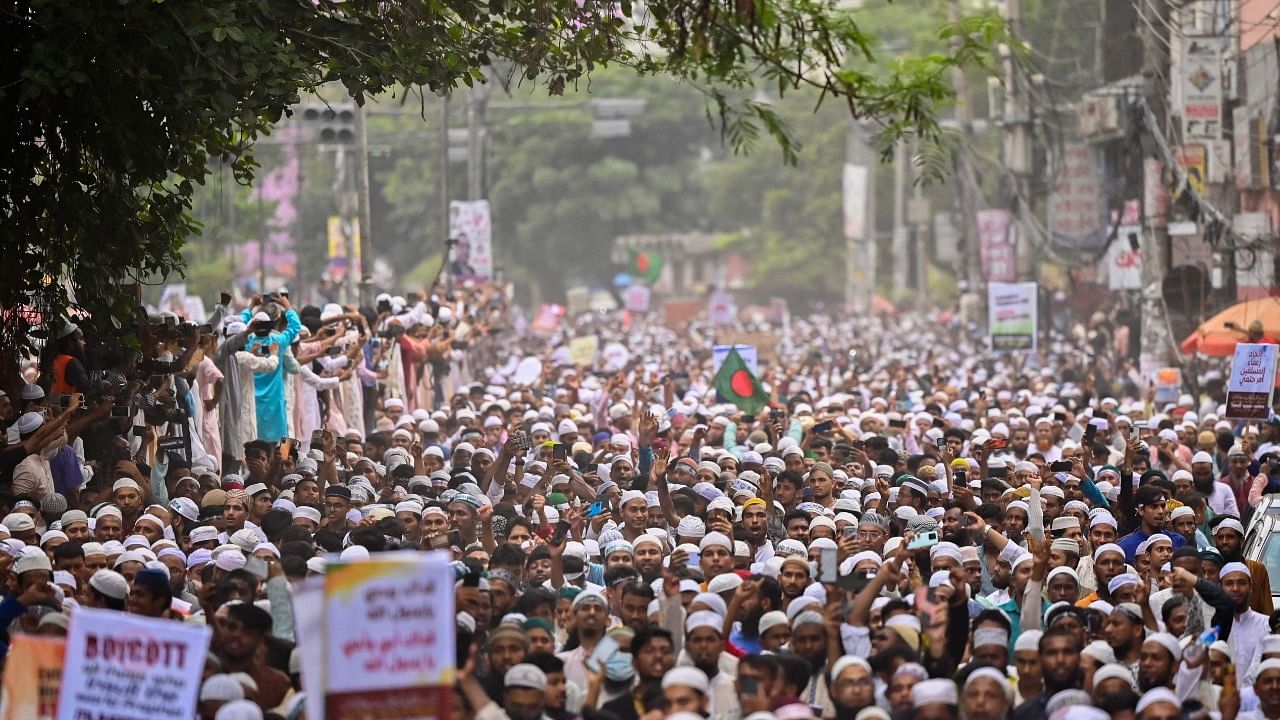 Bangladesh's Islamist parties' activists and supporters hold placards as they shout anti-India slogans during a demonstration in Dhaka on June 10, 2022. Credit: AFP Photo