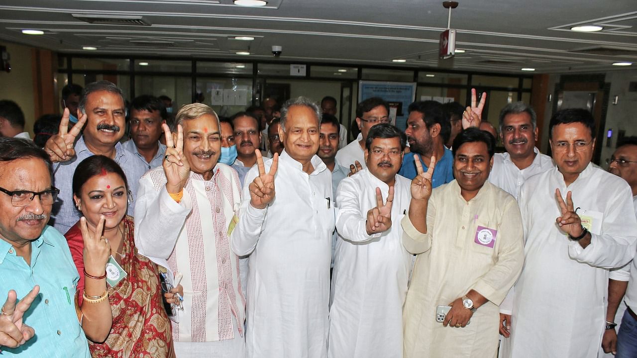 Rajasthan Chief Minister Ashok Gehlot with Congress candidate Pramod Tiwari, Mukul Wasnik and Randeep Surjewala and others flashes the victory sign during the Rajya Sabha election. Credit: PTI photo