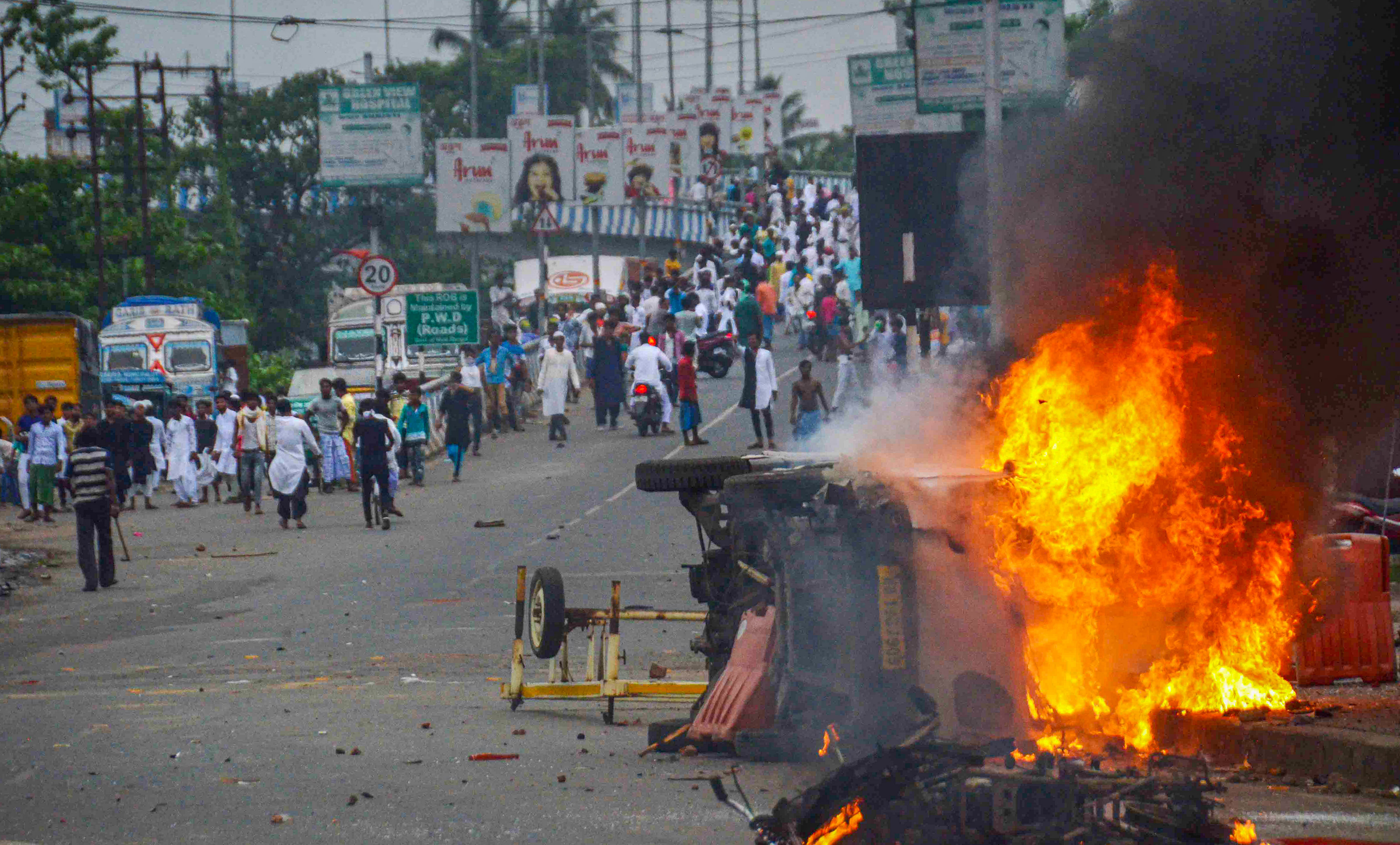 Flames and smoke rise from a vehicle on fire, that was allegedly set ablaze by miscreants during a protest over controversial remarks made by two now-suspended BJP leaders about Prophet Mohammad, in Howrah. Credit: PTI Photo