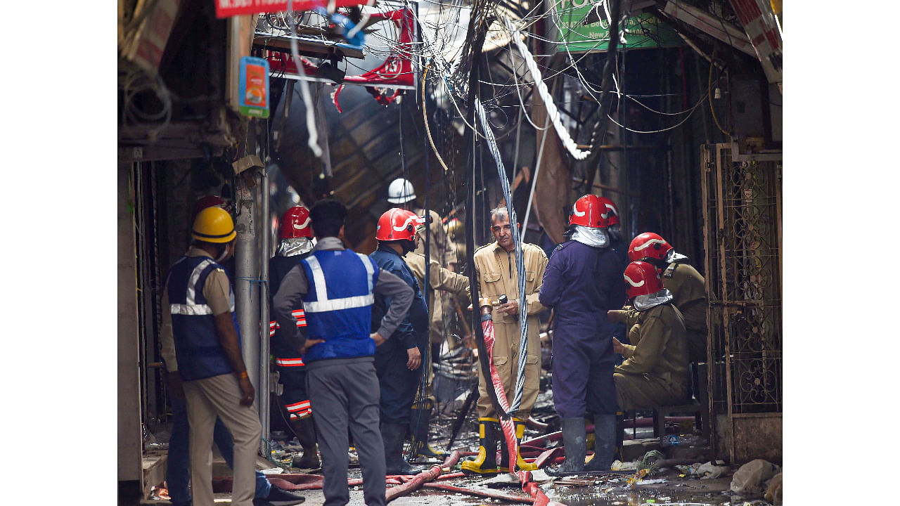 Firefighters at the site after fire broke out at Gaffar market, at Karol Bagh in New Delhi. Credit: PTI Photo